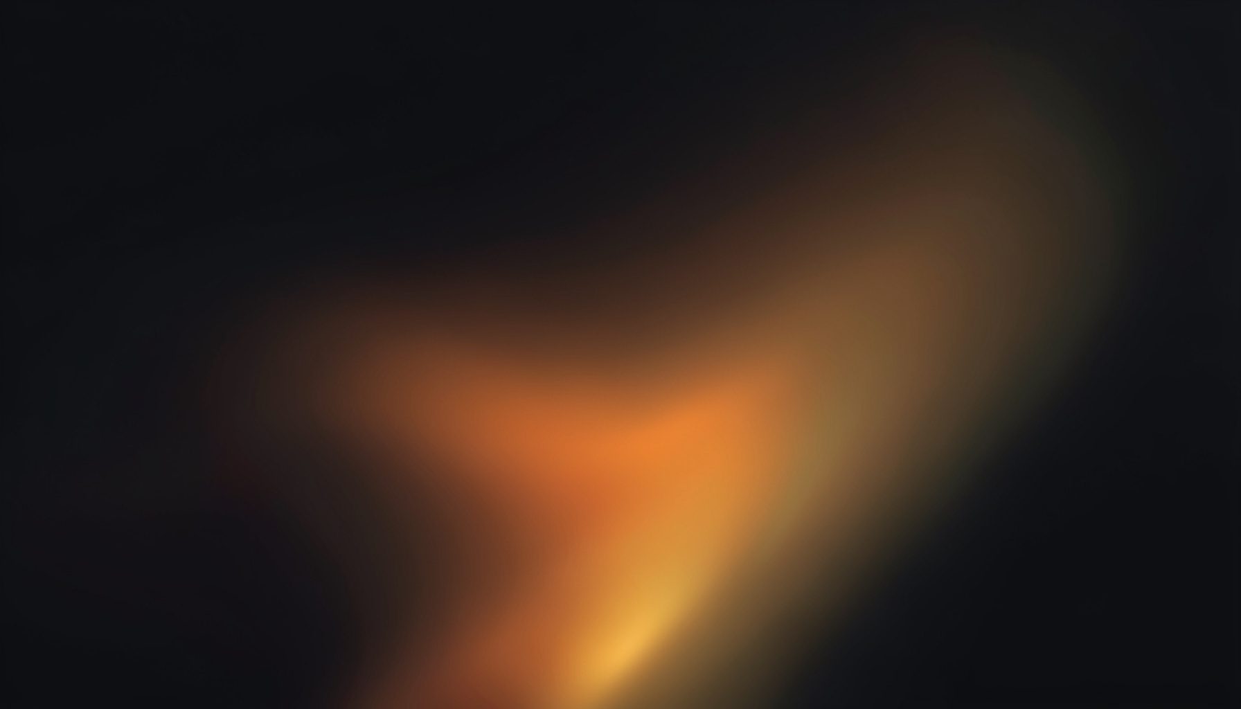 Dark atmospheric abstract gradient composition with deep charcoal tones fading into warm amber and gold highlights, conveying a sense of depth and understated sophistication.